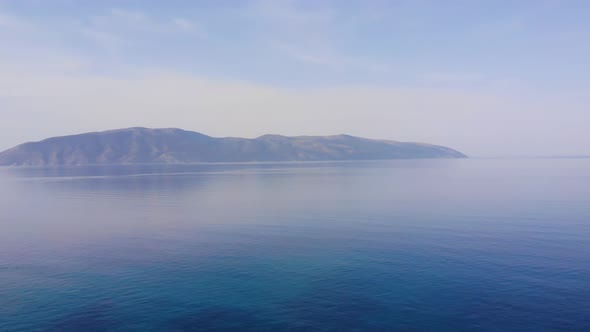 Ocean beach sunsets beautiful sky Aerial view drone camera. Island on horizon. Albania