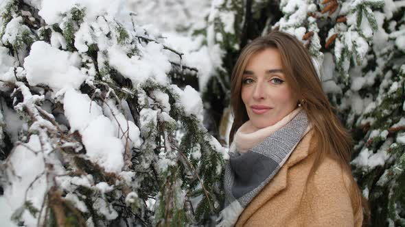 Girl in Snowy Tree Branches