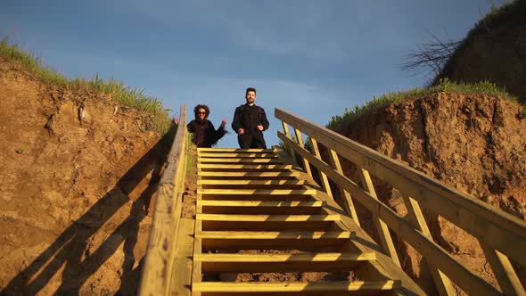 Happy Boy and Girl Rushing Down the Stairs Smiling Sky Slow Motion