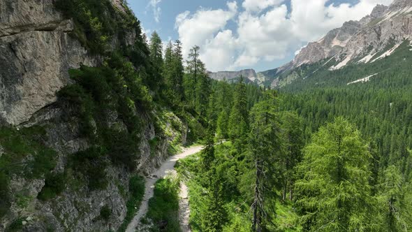 Hikers and travelers enjoy the beautiful mountain views as they have a walk in the Dolomites