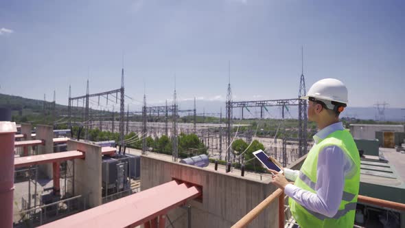 Engineer working with his tablet at the power plant.