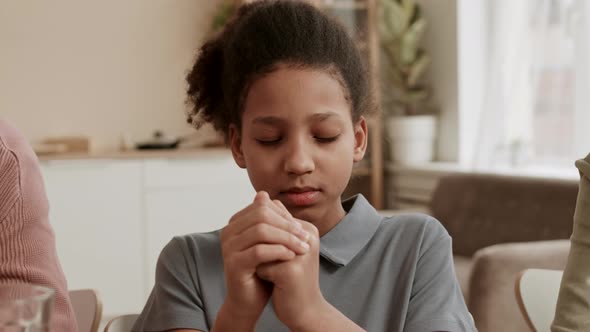 Afro School-aged Girl Praying Before Lunch