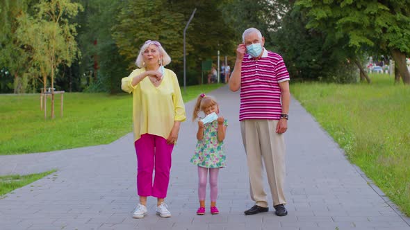 Quarantine Coronavirus is Over Senior Family Grandparents with Granddaughter Take Off Medical Masks