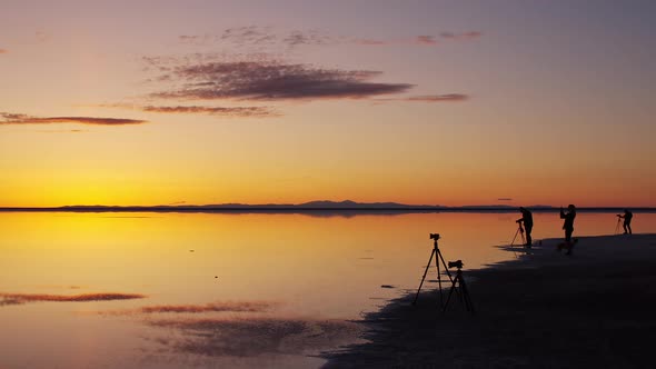 People photographing colorful sunrise over the Great Salt Lake