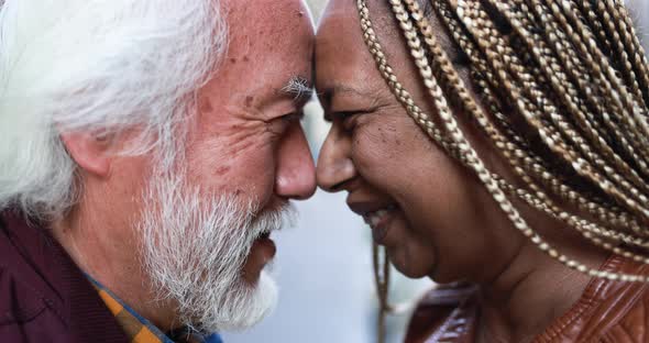 Multiracial senior couple having tender moment together outdoor