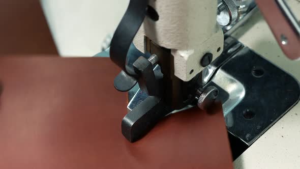 Worker Using an Automatic Leather Skiving Machine. Skiving Leather in a Haberdashery Manufactory