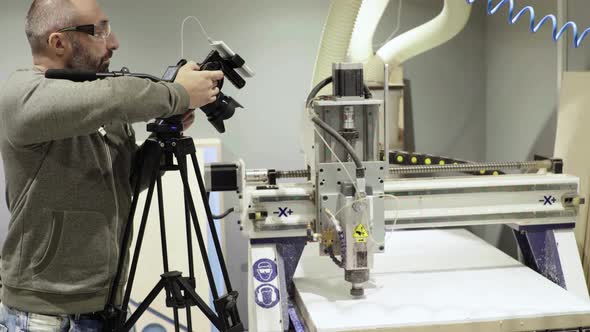 Close-up of a DSLR Camera in the Hands of a Cameraman Photographer While Shooting a Video Photo