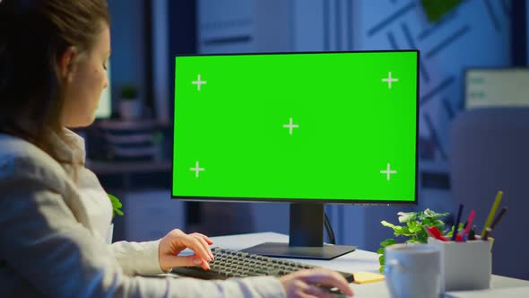 Freelancer Working in Front of Green Screen Display