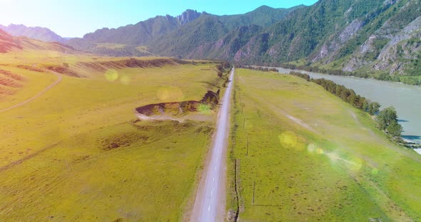 Aerial Rural Mountain Road and Meadow at Sunny Summer Morning