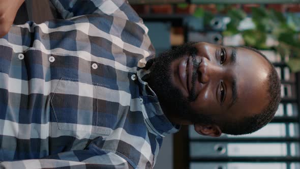 Vertical Video Portrait of African American Man Using Multi Monitors to Work