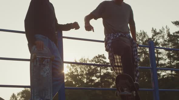 Teenagers with Skateboards Fist Bumping