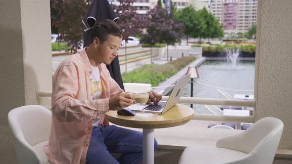 Young man drinking coffee while working.