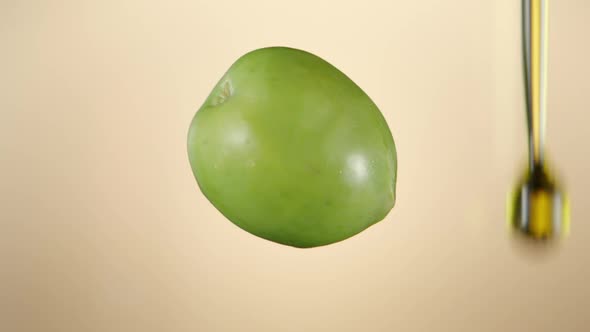Olive oil pouring on nude background