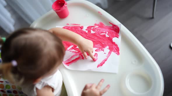 Cute Little Girl Painting with Fingers at Home