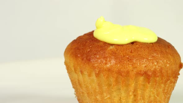 Pouring Yellow Glaze on Cupcake