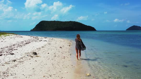 Beautiful ladies enjoying life on luxury bay beach wildlife by blue sea and white sandy background o