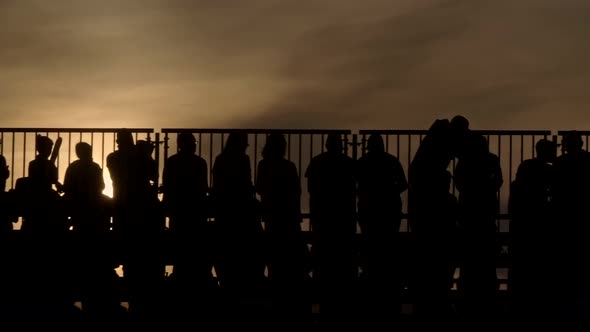 People In The Stands During Sunset