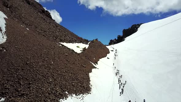 A Large Group of Climbers Climb To the Top