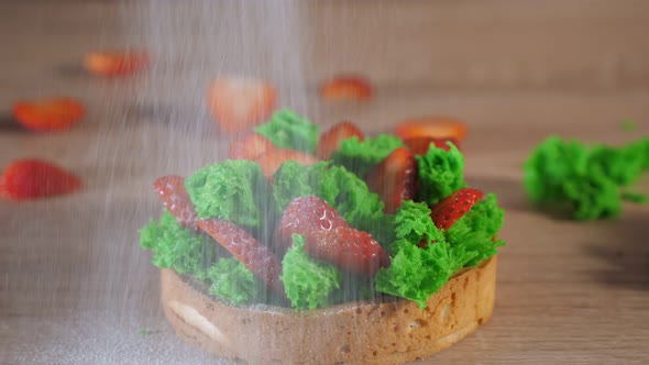 Mini Cake with Strawberry Slices and Cream on Biscuit Pouring with Powdered Sugar