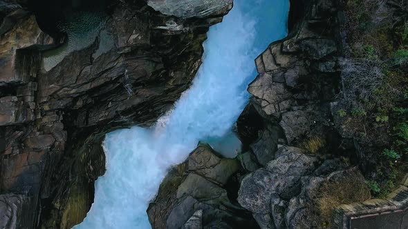 Top-down drone view above the stormy azure water a stone gorge of Athabaska River, Alberta, Canada