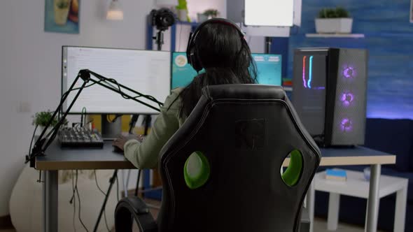 Back Shot of Streamer Woman Playing on Powerful Computer Shooter Game