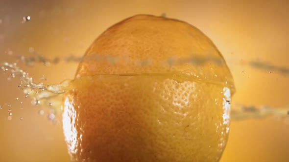 Half Lemon Falling and Splashing on Yellow Background