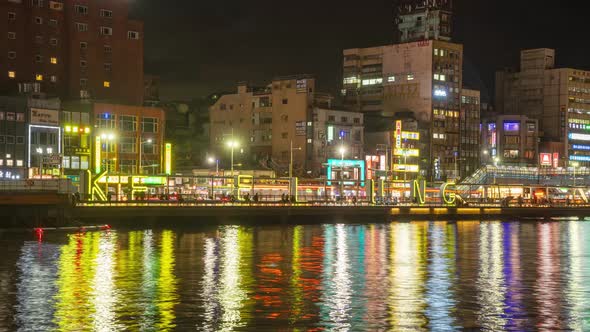 Cityscape Night Time Lapse of Crowded City at Keelung Harbor, Taiwan with Colorful Lights and LED si