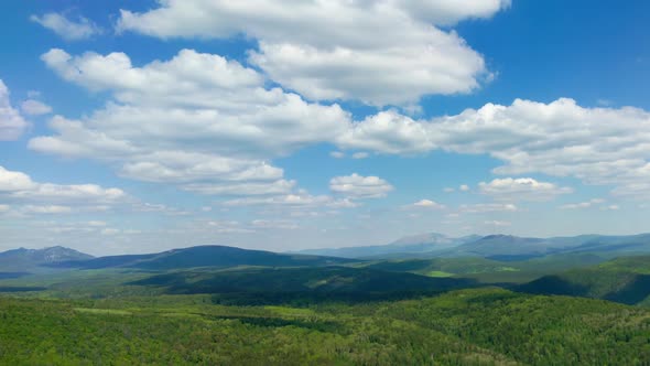 Landscape with Clouds Floating Across Sky Green Hills