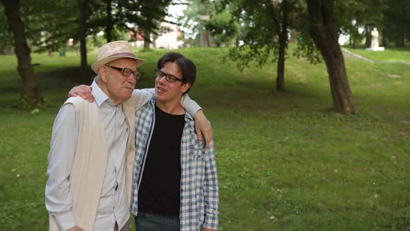 The Son and His Father are Standing in the Park and Enjoying the Moment