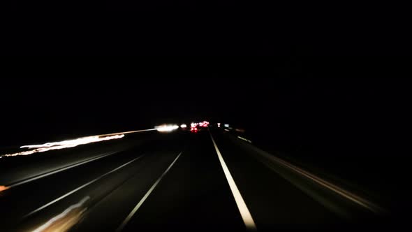 Time Lapse POV Driving on Highway at Night Blurred Traffic Light