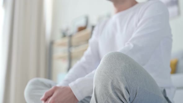 Close Up of Peaceful Man Meditating on Yoga Mat at Home
