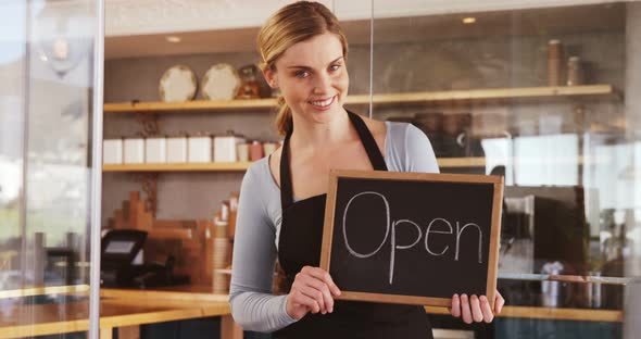 Smiling waitress with chalkboard