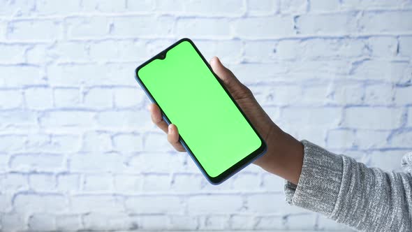 Close Up of Young Man Hand Using Smart Phone with Green Screen