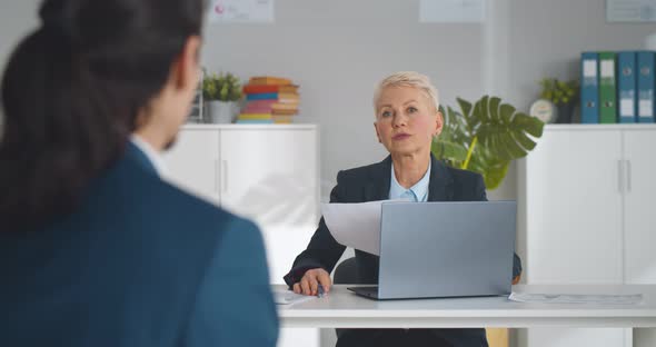 Mature Woman Employer Rejecting Young Male Job Applicant