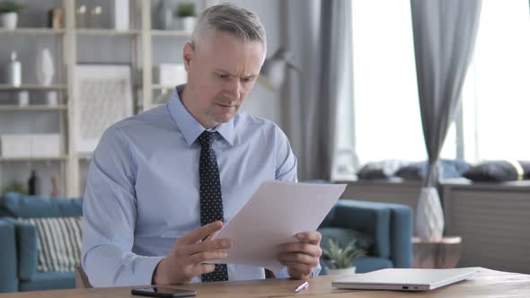 Gray Hair Businessman Excited After Reading Documents