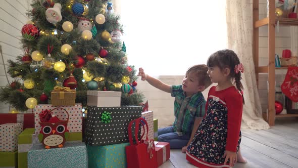 Happy Family and Merry Christmas. Mother and Her Kids at Christmas Morning at Xmas Tree