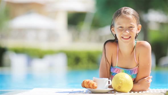 Adorable Little Girl Swimming at Outdoor Swimming Pool