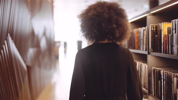 Young Woman Walking In Library