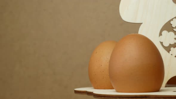 Rotation of eggs in an Easter stand made of wood on a gray background. Easter concept.close up