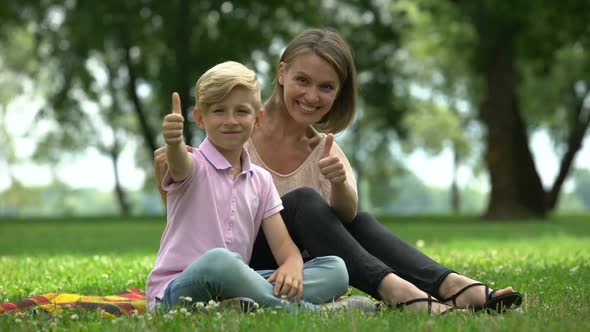 Happy Woman and Boy Showing Thumbs Up, Ad of Social Support for Single Mothers