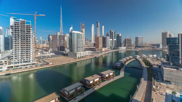 Skyscrapers Near Canal in Dubai with Blue Sky Aerial Timelapse