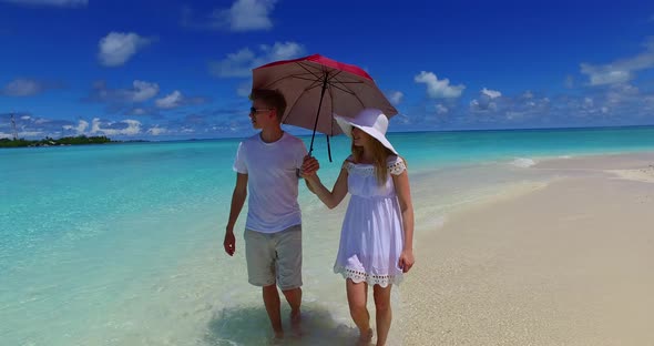 Beautiful lady and man married on vacation enjoy luxury on beach on clean white sand background