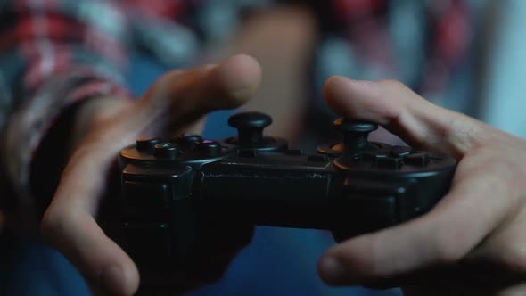 Young Male Playing Computer Games Holding Joystick, Addicted Person, Leisure