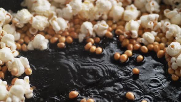 Camera tilting and shooting popcorn popping in fry pan. Slow Motion. alt