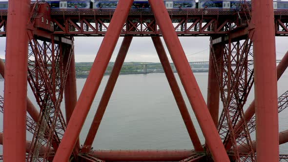 A Train Crossing a Red Bridge in Scotland