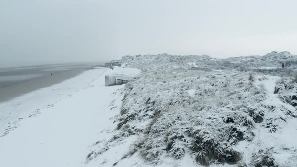 Dunkirk beach in snow, blockhaus, sand dunes and people (Dunkerque, France)