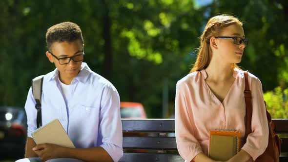 Timid Students in Glasses Trying to Make Acquaintance, Sitting on Bench in Park