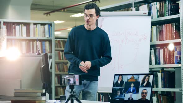 Online Lesson is Being Held By a Male Teacher in a Library