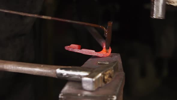 Close-up Shot of Beats Over Red Hot Iron Detail on Anvil in Forge