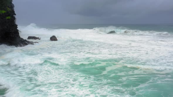 Small Secluded Wild Sandy Beach Surrounded By Cliffs Is Washed By Clear Transparent Waves. Aerial